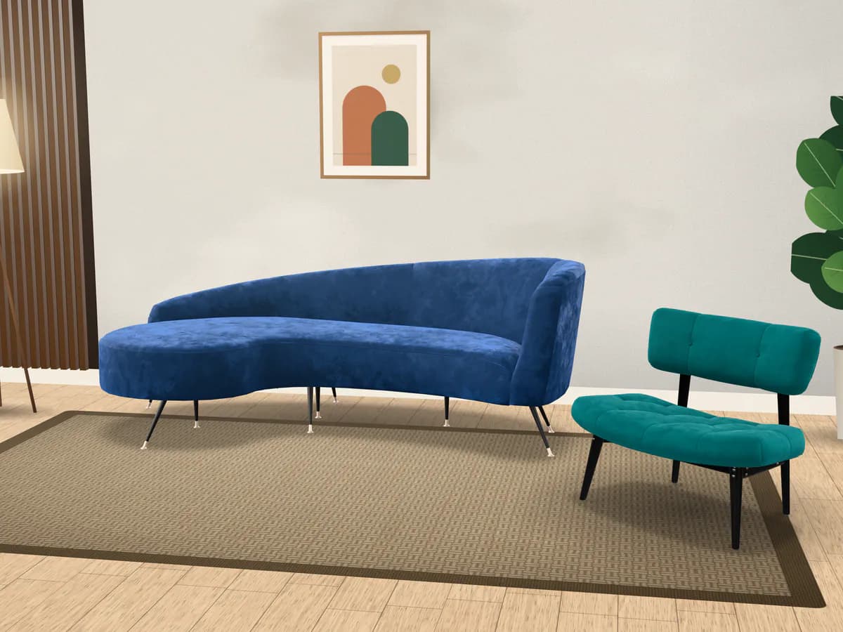 A blue velvet sofa and a matching accent chair in a lounge
